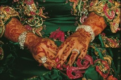 unrar:    A bride’s hands respendent with jewels and decorated with henna, Oman, James Stanfield.