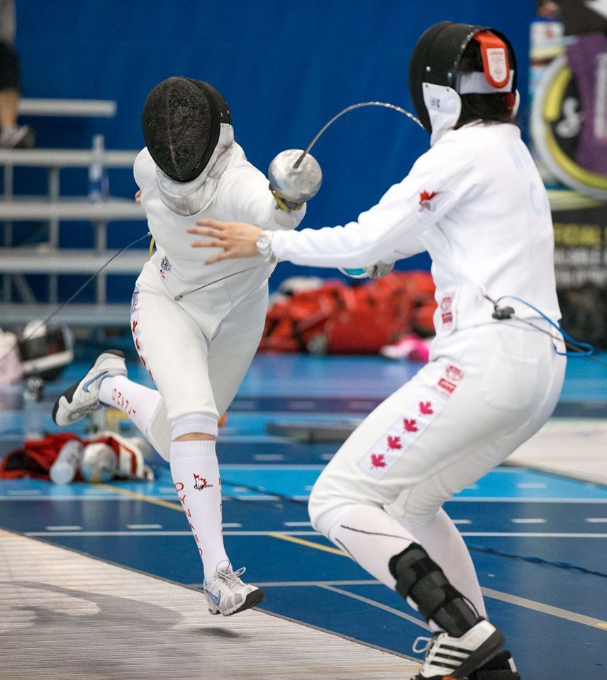 modernfencing:  [ID: an epee fencer fleching and hitting her opponent.]Fencing at
