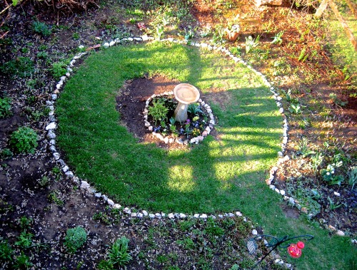 geopsych:  Hope returns to the garden.  The bare patch near the bird bath is from how big the ligularia grew last year, and it will grow to cover it this year! Looks like I need to spend some time rearranging the outer circle. Winter was harsh.