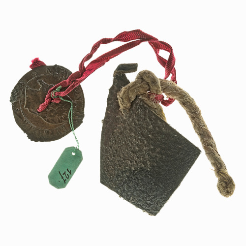 Acquired in Paris in 1889, this amulet is made from a perforated sou (low-value coin), a sectio