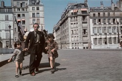 worldwar-two:  A man and his daughters hurry to seek shelter during an Allied air raid in occupied Paris, 1944. [x]