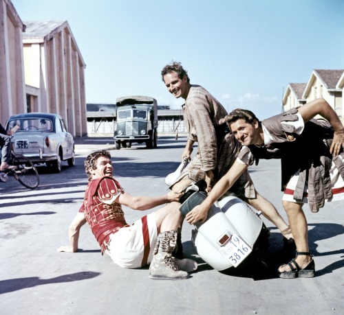 wisteria-lodge:Charlton Heston and Stephen Boyd messing around with a scooter on the set of Ben Hur (1959)