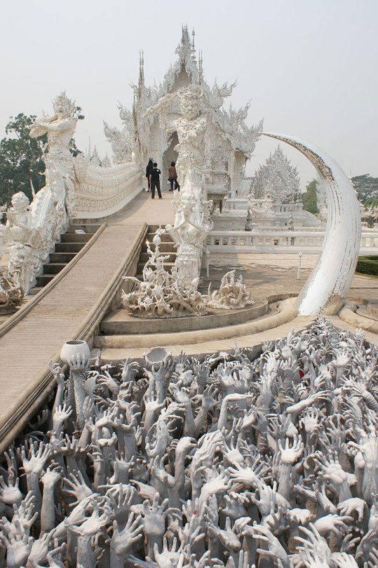 madeleineengland:  Wat Rong Khun, better known to foreigners as the White Temple, is a contemporary, unconventional, privately-owned art exhibit in the style of a Buddhist temple in Chiang Rai, Thailand. Chalermchai Kositpipat constructed it and