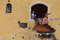 unrar:  Palestinian girls play at their family’s house, that witnesses said was damaged by Israeli shelling during a 50-day war last summer, in Khan Younis in the southern Gaza Strip, by Ibraheem Abu Mustafa.