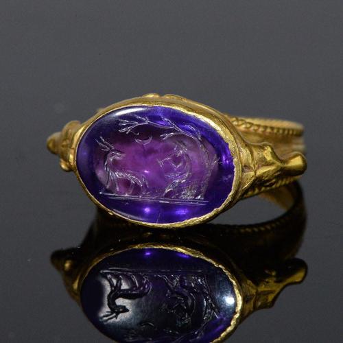 gemma-antiqua: Ancient Roman gold ring with an amethyst intaglio of Pan playing the pipes as a goat 