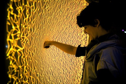 wetheurban:  DESIGN: Firewall by Aaron Sherwood Artist Aaron Sherwood creates magic as a sheet of spandex becomes a tactile membrane the public can interact with. The surface creates amazing fire-inspired visuals and music as visitors push their hands
