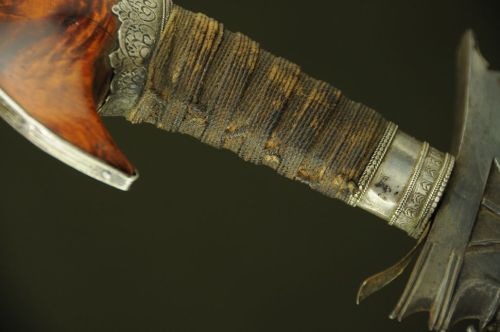 art-of-swords:  Moro Keris SwordDated: 19th centuryCulture: IndonesianMedium: iron, silver, rope, woodMeasurements: overall length 29.25 inches (74.3cm); blade length 22.75 inches (57.8cm)The sword’s pommel measures 4.5 inches from tip to top and is