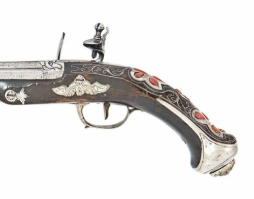 A pair of coral and silver mounted flintlock pistol originating from Northern Italy.  Produced for t