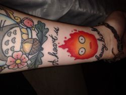 whyisyourtattooupsidedown:  babyfireflyy:  My new Calcifer tattoo that reads “a heart is a heavy burden”Definitely getting there on my ghibli sleeve  good ghibli tattoos are a breath of fresh air