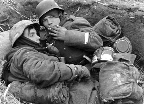 Young Germans smoking in a trench while defending Berlin, 1945