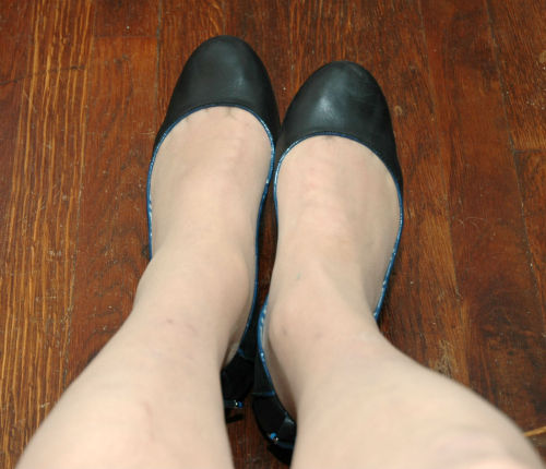Navy Tommy Hilfiger flats and nude sheer-to-the-waist pantyhose. Left thumb in my mouth,