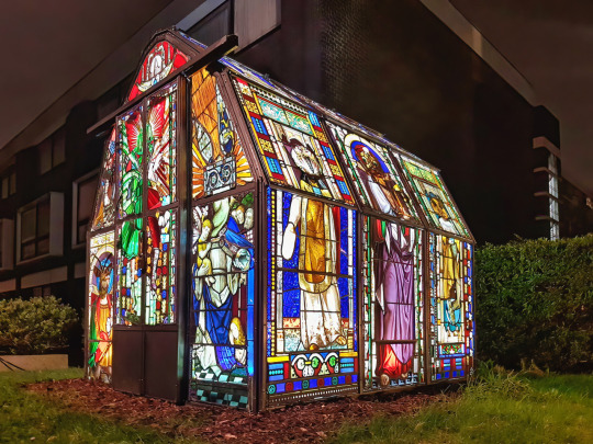 Greenhouse made from recycled church stained glass windows by Heywood & Condie.