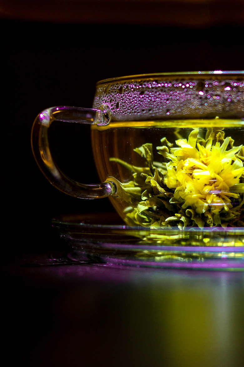 accras:  A cup of tea with a chrysanthemum inside