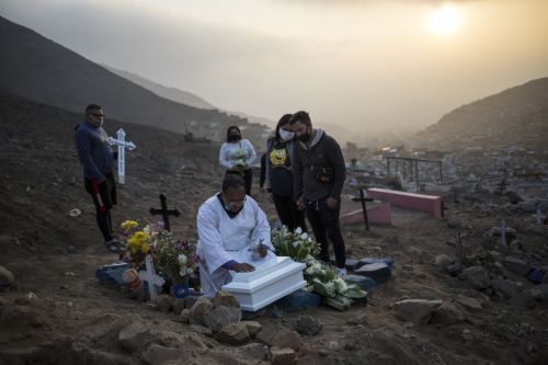 Brother Ronald Marin, originally from Guacara, Venezuela, prays over the coffin that contains the re