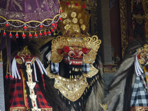 Masks of Barong and Rangda worshiped at balinese temple