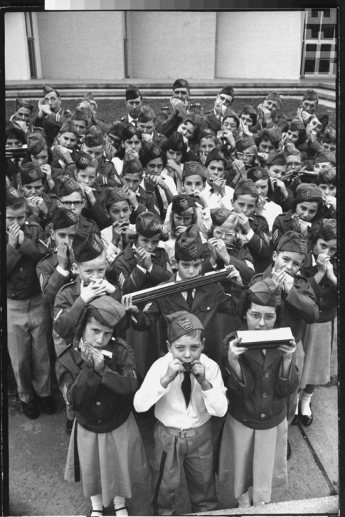 Children who are members of the 105-member Levittown Harmonica Band playing harmonicas