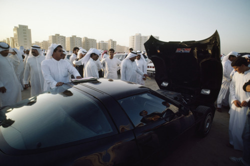 Shoppers inspect a Corvette at a daily auto auction in Kuwait City, November 1987.Photograph by Stev