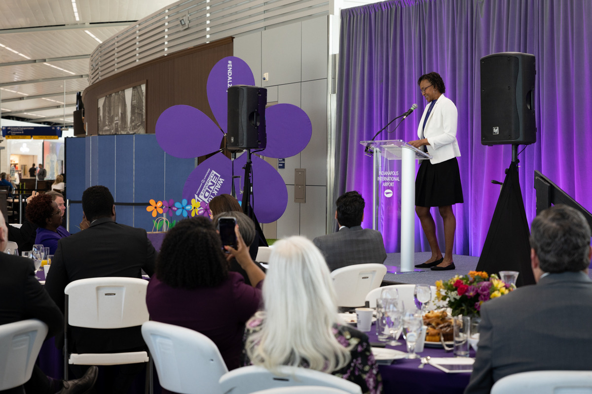 Tamika Catchings speaks to a gathering of people at the Indianapolis International Airport.