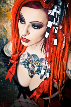 gothedup:  Cyber goth girl with orange dreadlocks, black clothes, and tattoos