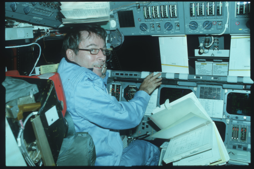 Flight Commander John Young Reviewing Checklists Aboard Space Shuttle Columbia, STS-1