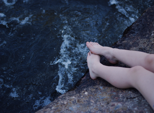 I know. My feet look pale and unwell against this deep black sea, my flesh too soft for these callou