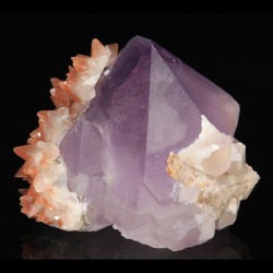 fuckyeahmineralogy:  Quartz var. Amethyst with Hematite included Calcite; Tonglushan Mine, China