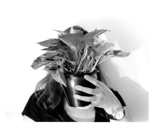 3.13.16 - A photo from my film photography course. Here I am hiding my face with my first plant, my 