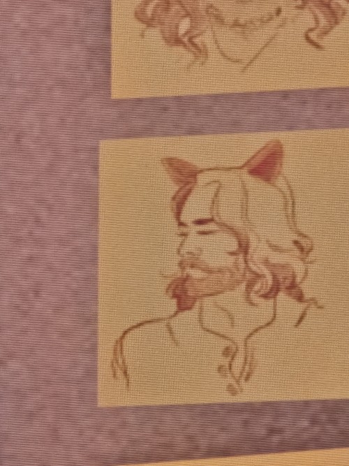 a post it note in a video game, portraying character Alan Wake, with cat ears drawn on him.