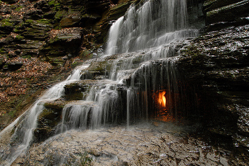 sixpenceee:  Eternal Flame Falls The Eternal Flame Falls is a small waterfall located in the Shale Creek Preserve, a section of Chestnut Ridge Park in Western New York. A small grotto at the waterfall’s base emits natural gas, which can be lit to produce