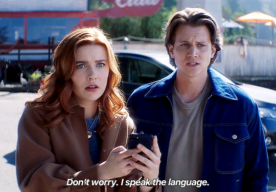GIF FROM EPISODE 3X07 OF NANCY DREW. NANCY AND ACE ARE STANDING IN THE PARKING LOT OF THE CLAW LOOKING IN HORROR AT SOMETHING OUT OF FRAME. ACE SAYS "DON'T WORRY. I SPEAK THE LANGUAGE."