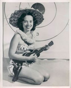 uketeecee:She strums an old Martin style 3 ukulele and packs a Colt 45.