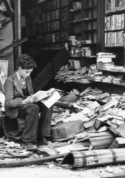 historicaltimes: A boy sits amid the ruins of a London bookshop following an air raid on October 8, 1940, reading a book titled “The History of London.” via reddit 