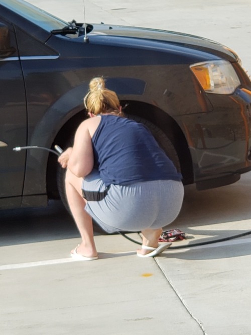Creep shots of a hottie airing up her tire.