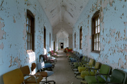 ianference:  Violent ward hallway in the main complex at St. Lawrence State Hospital, used to store a variety of colored desk chairs when the asylum was abandoned. 