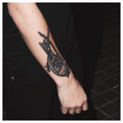   The meaning of a sparrow on the arm is symbolic of freedom     