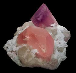 earthstory:  Morganite with Kunzite  Sitting on its 27x20cm matrix of Afghan Quartz and Clevelandite feldspar, we have two minerals born in the dying remnants of cooling granites. The pink to peachy variety of beryl called Morganite *the pink crystal