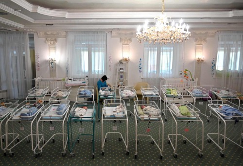 agelessphotography: A nurse cares for newborn babies at the Venice hotel in Kyiv where more than 100