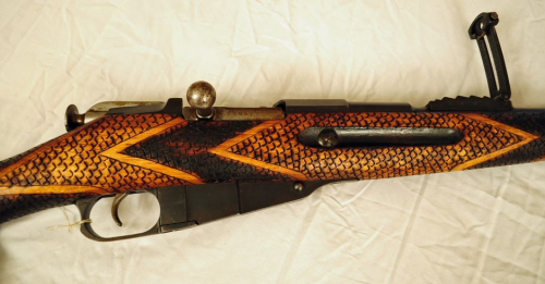 An interesting Finnish M91 Mosin Nagant bolt action rifle, with hand carved &ldquo;snakeskin&rdquo; 