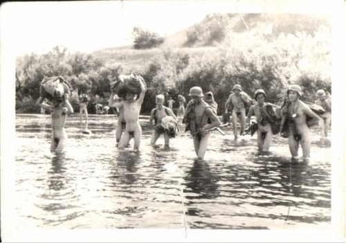 vintagemusclemen:Large group of skinny German troops crossing a shallow river, World War II.