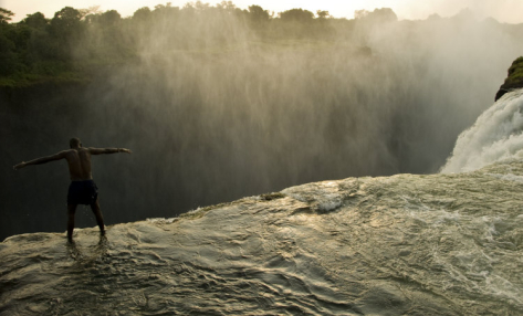sapta-loka: mother nature’s infinity pool, atop the 108 meter drop of victoria falls, photogra