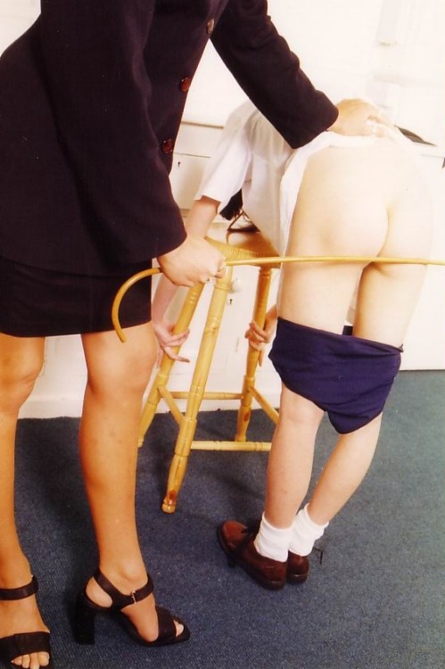 paddlemaster: bringbackthecane:disciplinarianukAs her Housemistress bends the senior teen girl over 