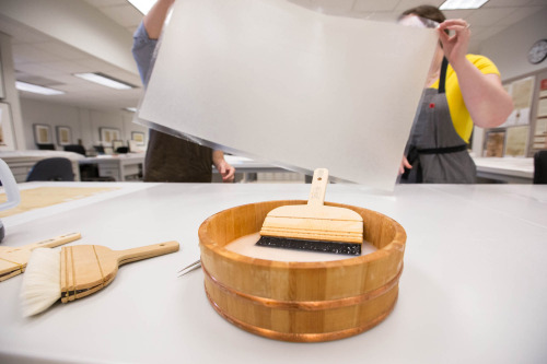 Treaty of Fort Pitt- realigning the record on a light table and lining the document with Japanese pa