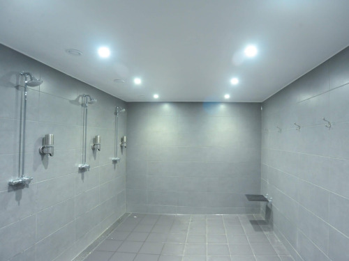 Men’s shower and bathroom at Crowborough Golf Club in Crowborough, UK.The men’s washroom