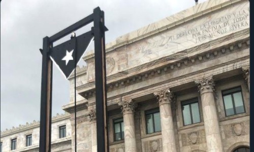 physcomitrium:physcomitrium:puerto rico setting up a guillotine in front of the governers