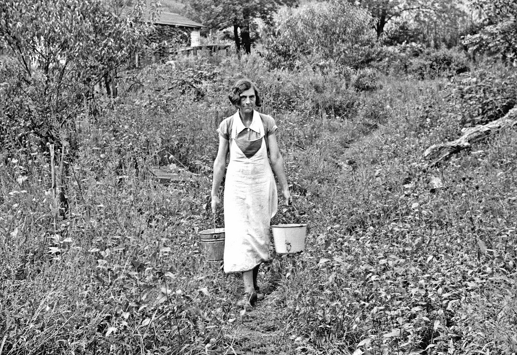  Coal miner’s wife carrying home water from the hill, Bertha Hill, West Virginia,