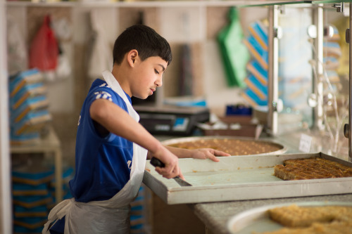 quranic-recitations:unicef:Mohammed, a Syrian refugee, works 12-hour shifts in a sweets shop to support his family.“[M]y mother is ill, and so is my dad. I have five sisters, and I’m the only son…I feel there’s pressure on me. I must work. If