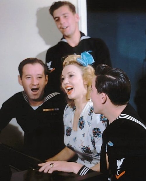 Carole Landis sings with sailors at the Hollywood Canteen, c.1942