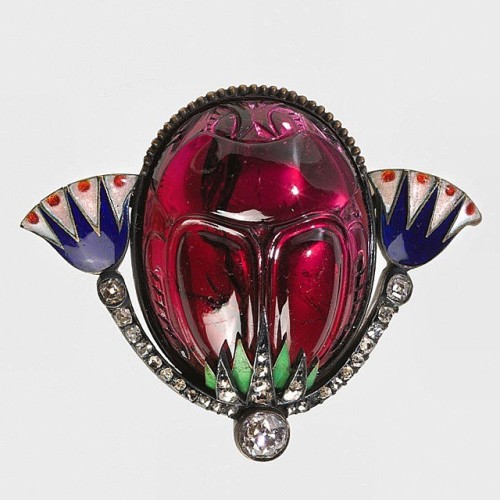 A rhodolite garnet scarab with diamond and enamel accents by Fabergé. Via Victoria and Albert Museum