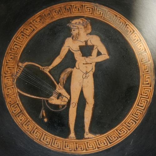 Silenus or a satyr, holding a kantharos (drinking-cup) and lyre.  Tondo of an Attic red-figure kylix