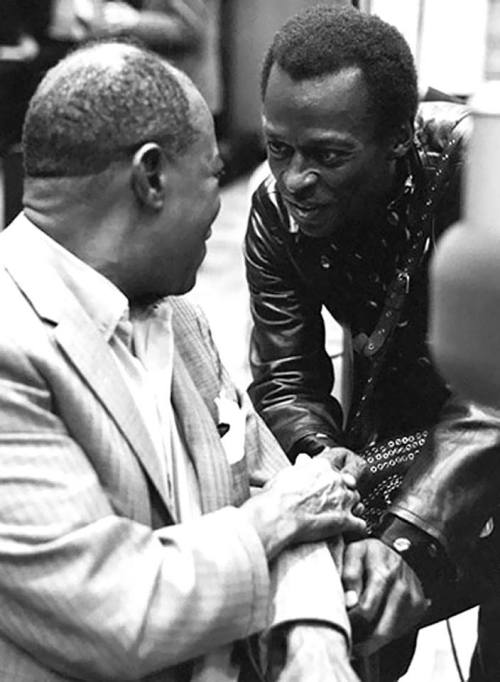 Louis Armstrong and Miles Davis, 1970.Photo by Jack Bradley